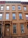 One of the brownstone buildings on St. James St. in Brooklyn. Undivided, the houses go for a million today.