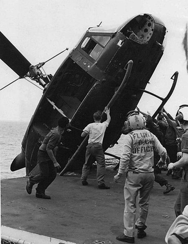 South_Vietnamese_helicopter_is_pushed_over_the_side_of_the_USS_Okinawa_during_Operation_Frequent_Wind,_April_1975